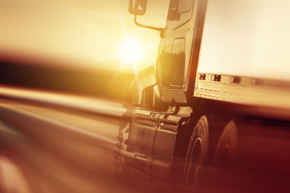 Common Reasons for Truck Accidents - Semi Truck In Motion. Speeding Truck on the Highway. Trucking Business Concept