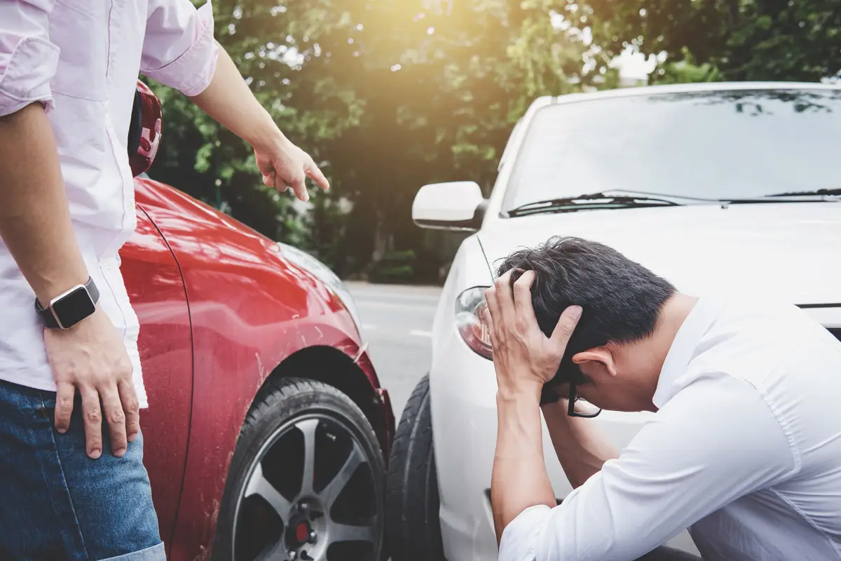 Two drivers man arguing after a car accident